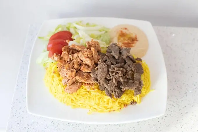 Halal chicken shawarma plate with rice and hummus at Original Shawarma Calgary